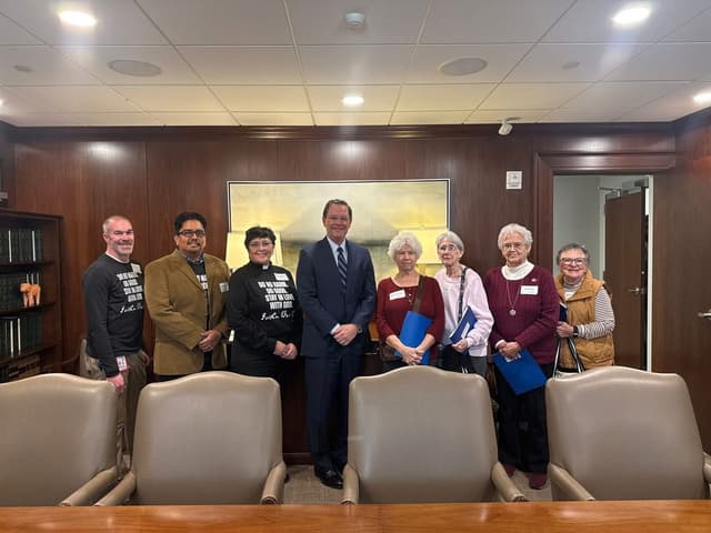 Monica and community members meeting with a legislator at the state capitol