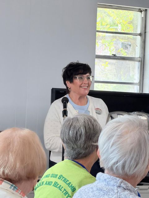 Monica smiling while addressing supporters at a Cumberland County Democrats event
