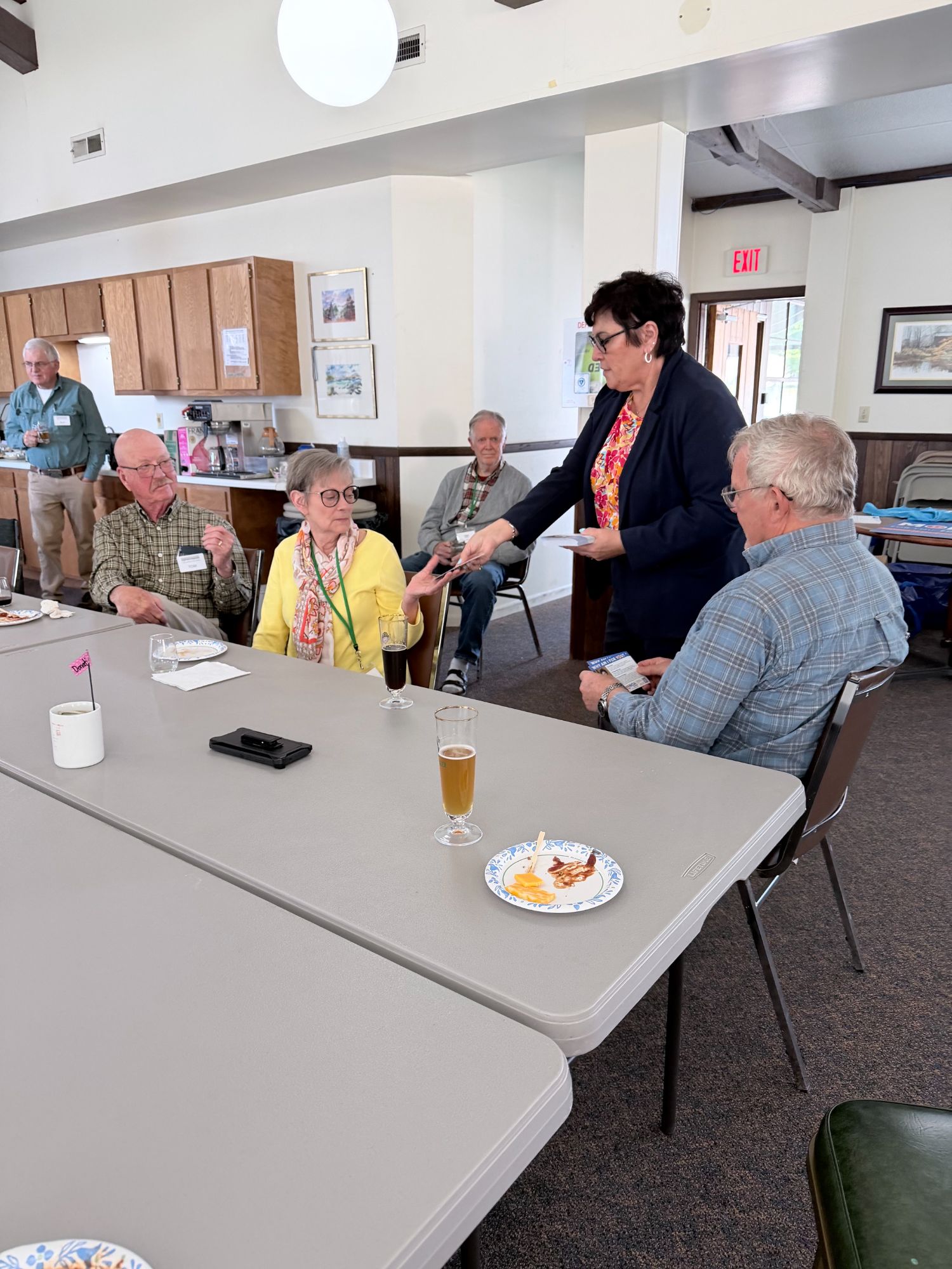 Monica handing a campaign card to a supporter at the Pleasant Hill Meet & Greet